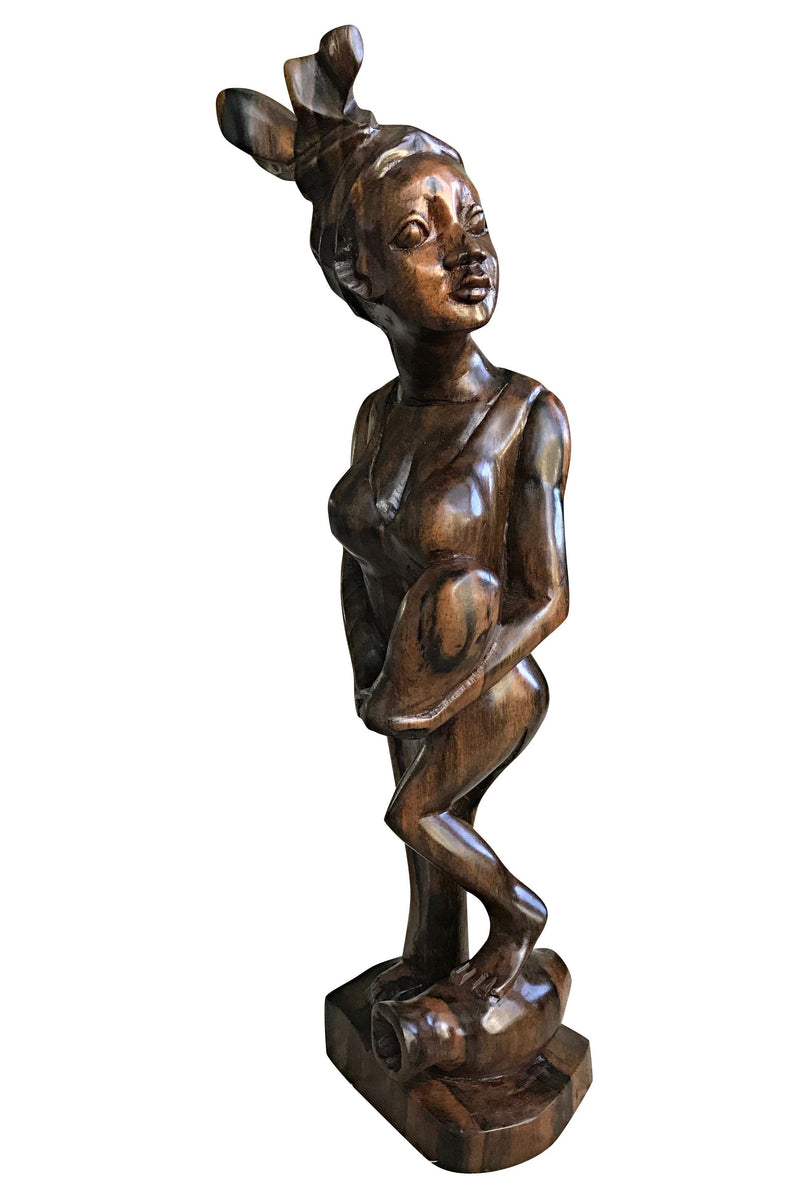 Ebony Hand Carving African Figurines statues / Woman wearing headwrap, holding an empty jar and a foot on another jar - Afrilege